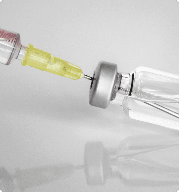 A yellow needle is being used to make an injection.